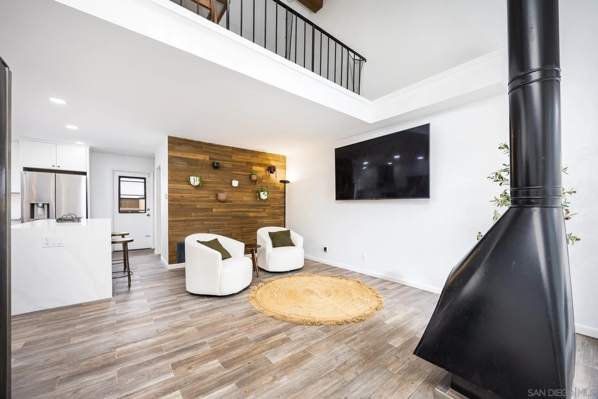 3568 Front Street, Unit D San Diego, CA 92103 - Photo 3 of 24 a living room with furniture and a flat screen tv