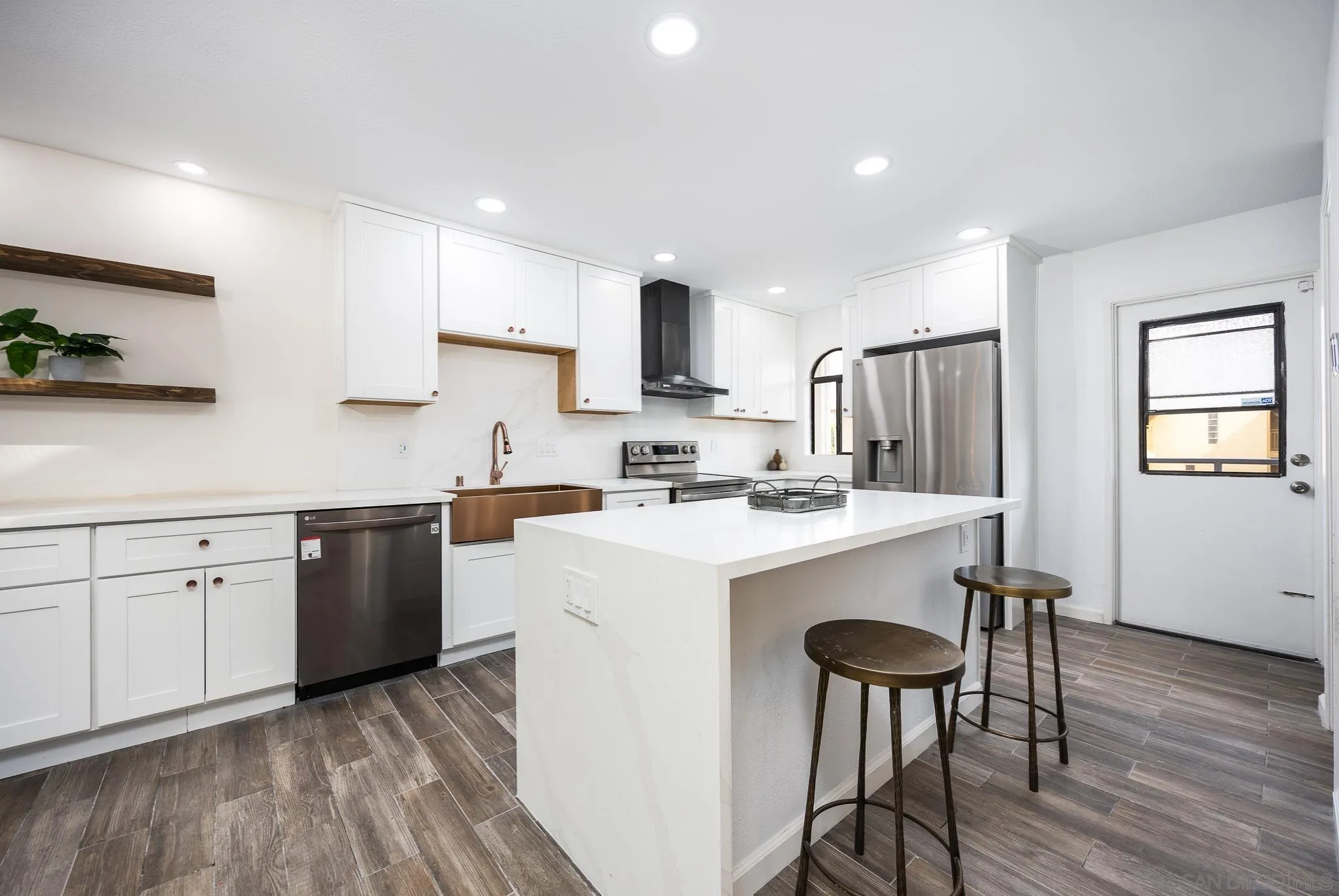 3568 Front Street, Unit D San Diego, CA 92103 - Photo 6 of 24 a kitchen with a sink a stove a refrigerator and white cabinets with wooden floor