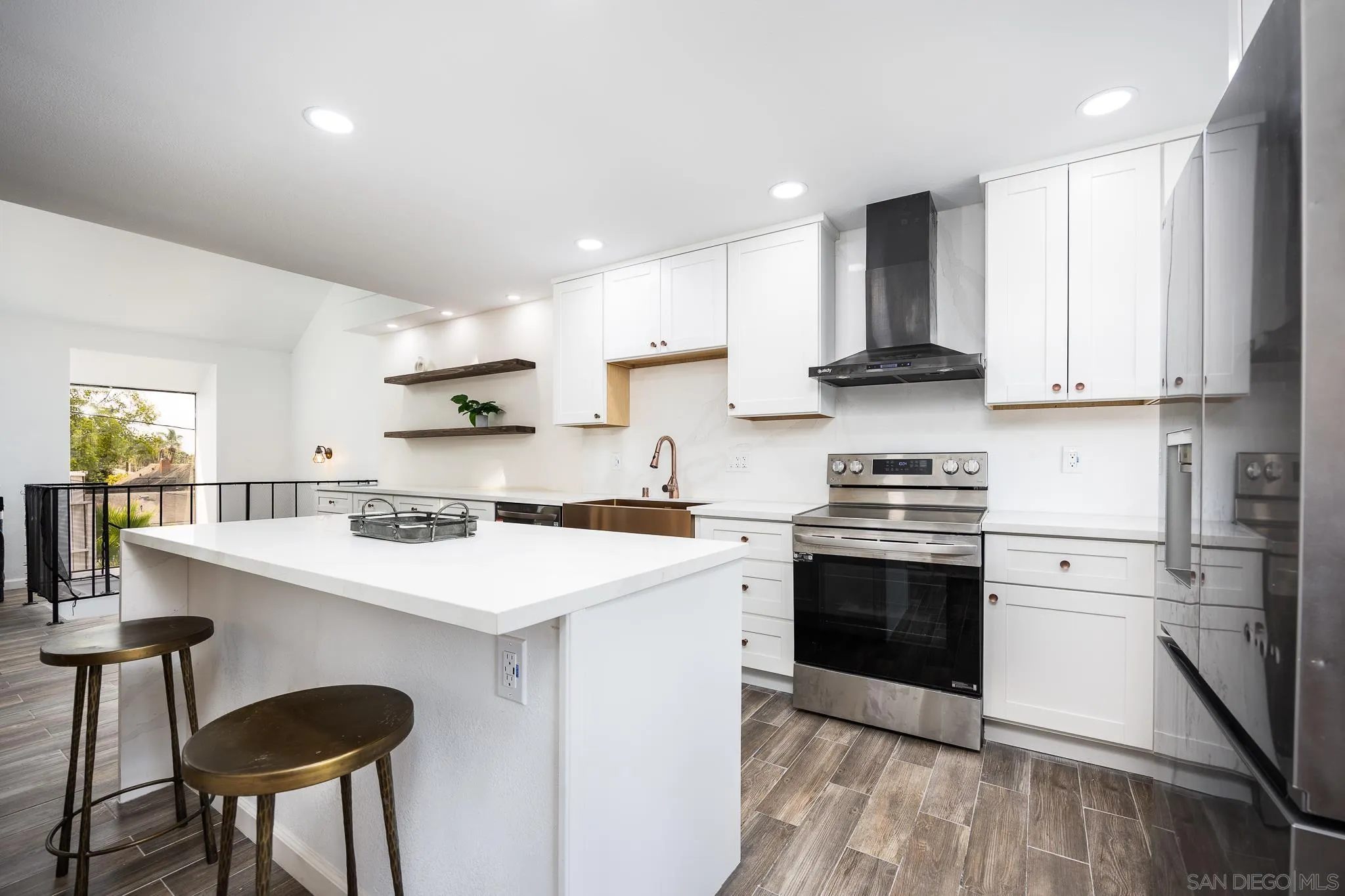 3568 Front Street, Unit D San Diego, CA 92103 - Photo 7 of 24 a kitchen with stainless steel appliances granite countertop a stove a sink a refrigerator and white cabinets with wooden floor