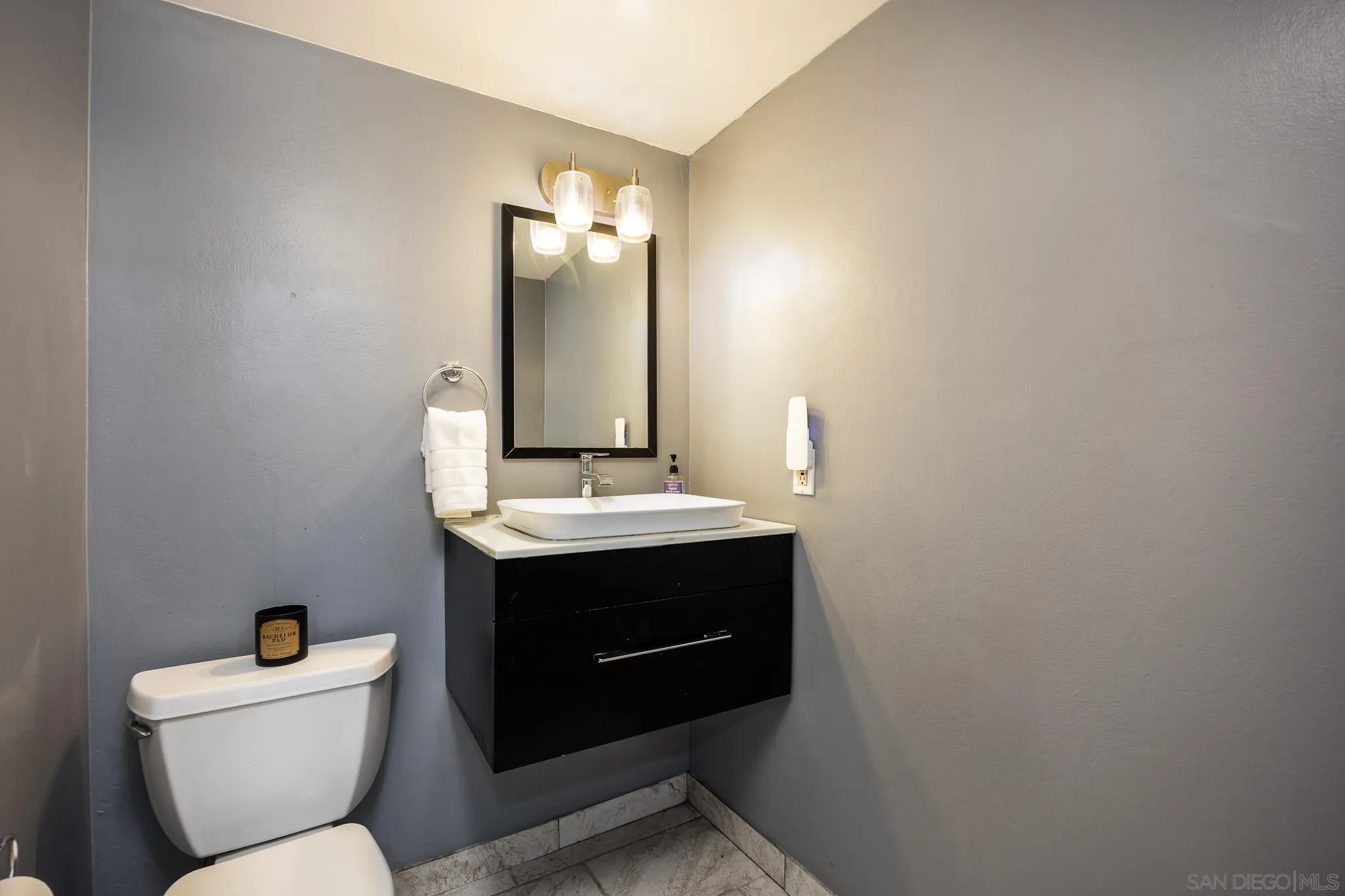 3568 Front Street, Unit D San Diego, CA 92103 - Photo 8 of 24 a bathroom with a toilet sink and mirror