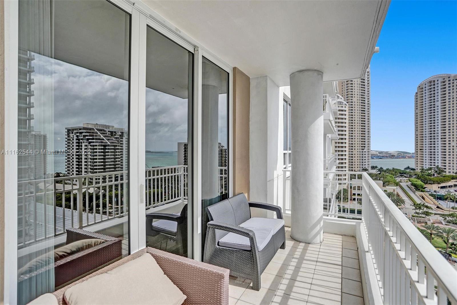 801 Brickell Key Boulevard, Unit 1507 Miami, FL 33131 - Photo 5 of 26 a view of a balcony with wooden floor and furniture