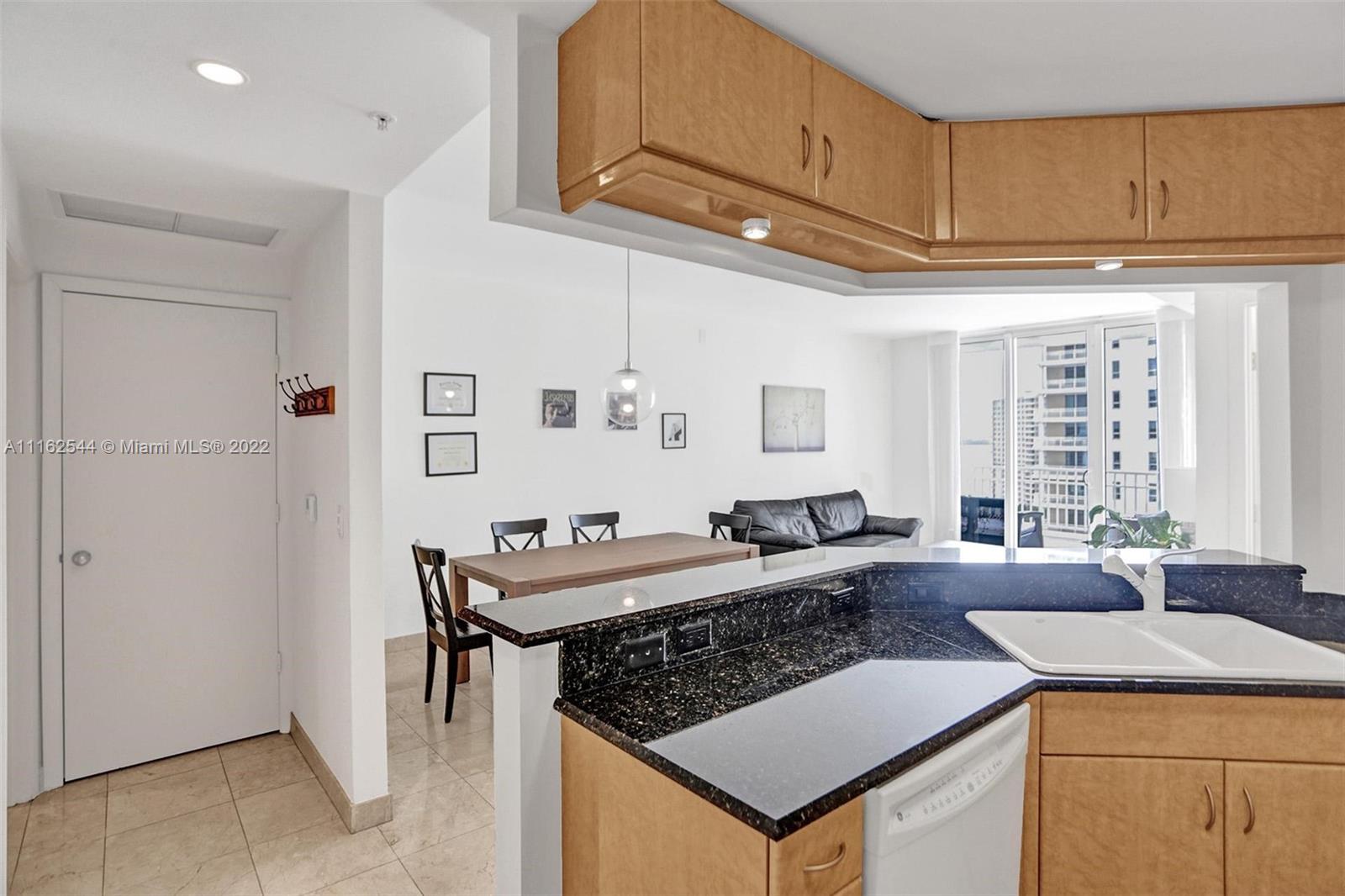 801 Brickell Key Boulevard, Unit 1507 Miami, FL 33131 - Photo 7 of 26 a living room with stainless steel appliances granite countertop furniture and a kitchen view