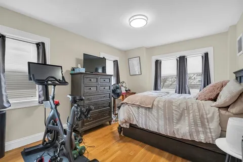 a bed room with a bed tv and a window