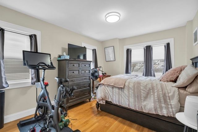 a bed room with a bed tv and a window