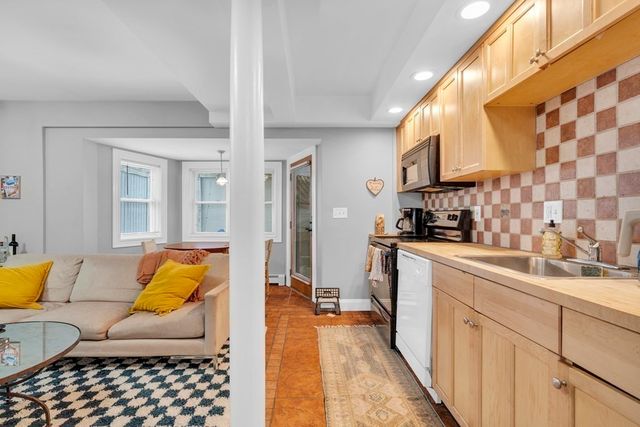 a living room with furniture and a rug