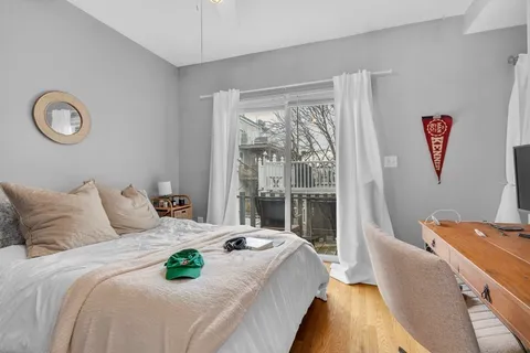 a bedroom with a bed and a large window