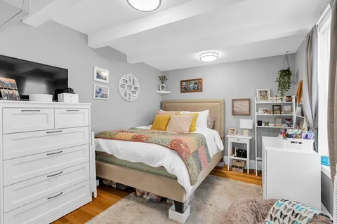 a bedroom with a bed and flat screen tv