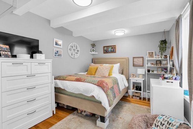 a bedroom with a bed and flat screen tv