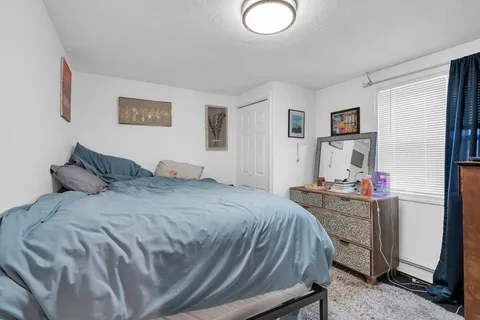 a bed room with a bed and a desk