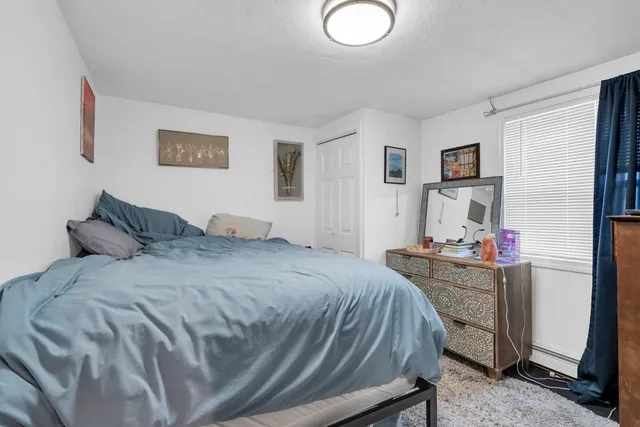 a bed room with a bed and a desk