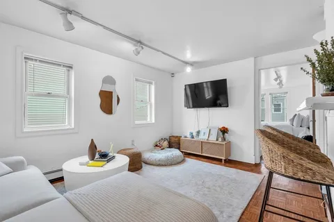 a bedroom with furniture and a flat screen tv