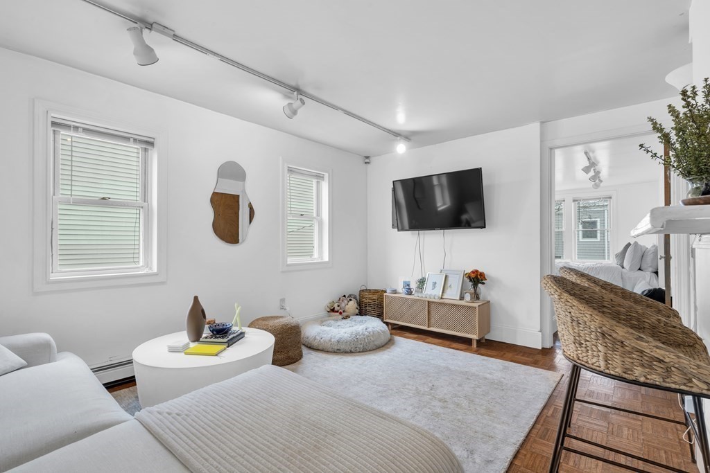 493-495 East 7th Street Boston, MA 02127 - Photo 3 of 22 a bedroom with furniture and a flat screen tv