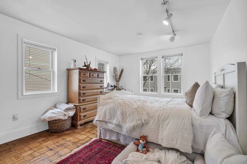 493-495 East 7th Street Boston, MA 02127 - Photo 4 of 22 a bedroom with a bed and wooden floor