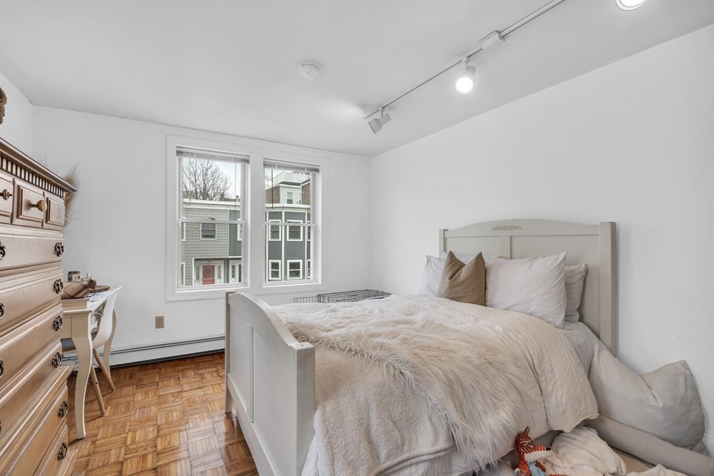 493-495 East 7th Street Boston, MA 02127 - Photo 5 of 22 a bedroom with a bed and a window