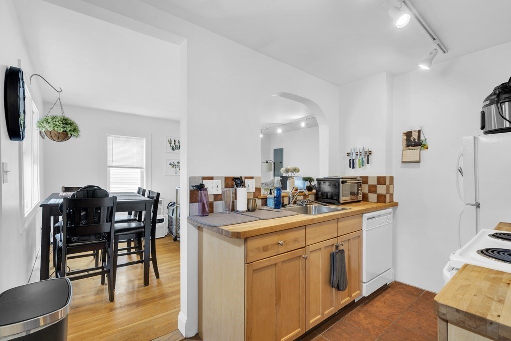 493-495 East 7th Street Boston, MA 02127 - Photo 7 of 22 a kitchen that has a cabinets and a table in it