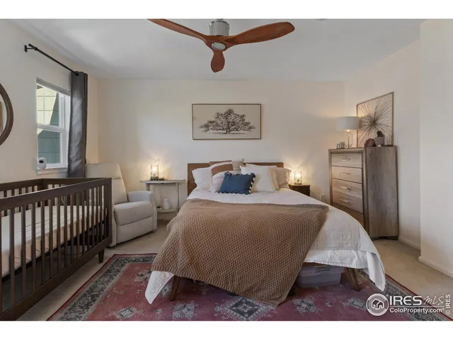 a bedroom with a bed a couch and a window