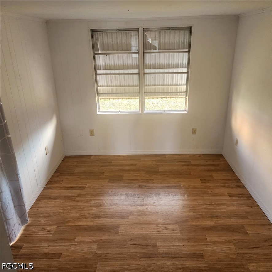 110 Gaslight Avenue North Fort Myers, FL 33917 - Photo 7 of 22 a view of empty room with wooden floor and fan