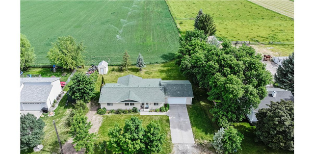435 East 4th North Preston, ID 83263 - Photo 21 of 26 Ranch-style residence featuring a prominent front-facing garage, a paved driveway, and mature landscaping