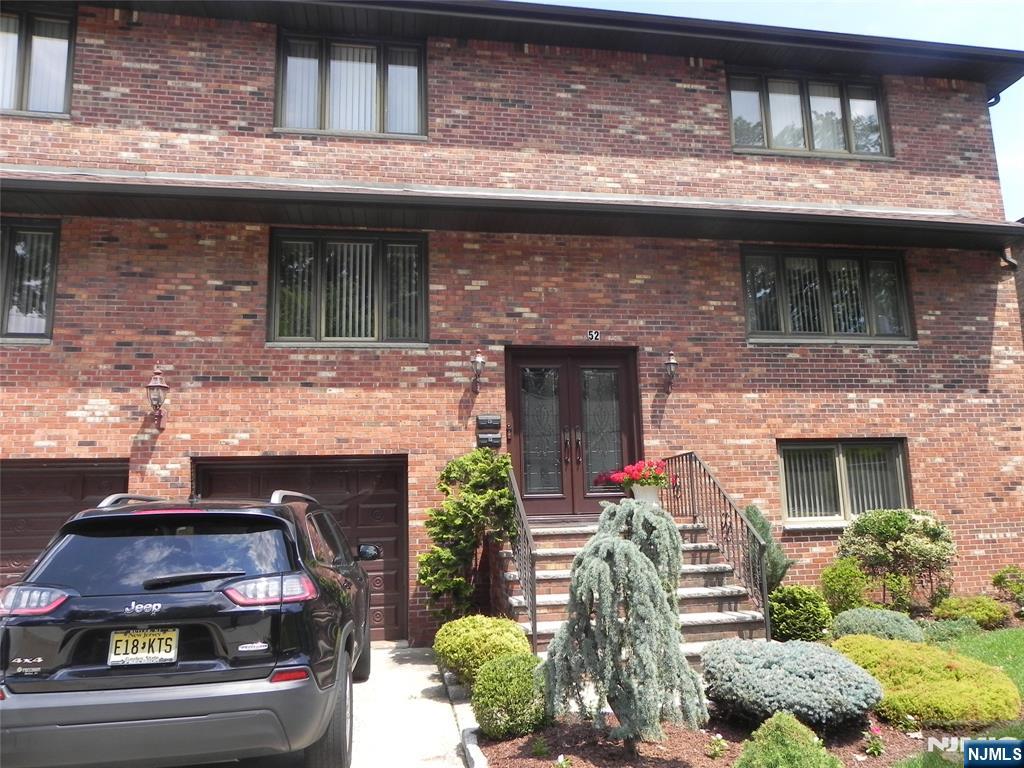 52 Wilson Street, Unit 2 Little Ferry, NJ 07643 - Photo 1 of 11 a front view of a house with plants
