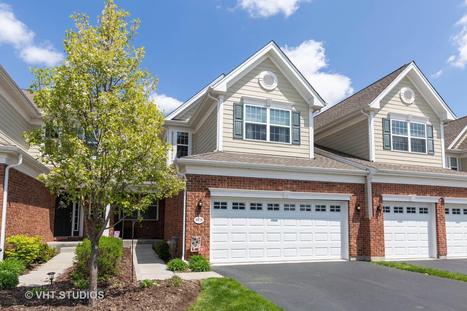 1175 Falcon Ridge Drive, Unit 1175 Elgin, IL 60124 - Photo 1 of 17 a front view of a house with a yard and garage
