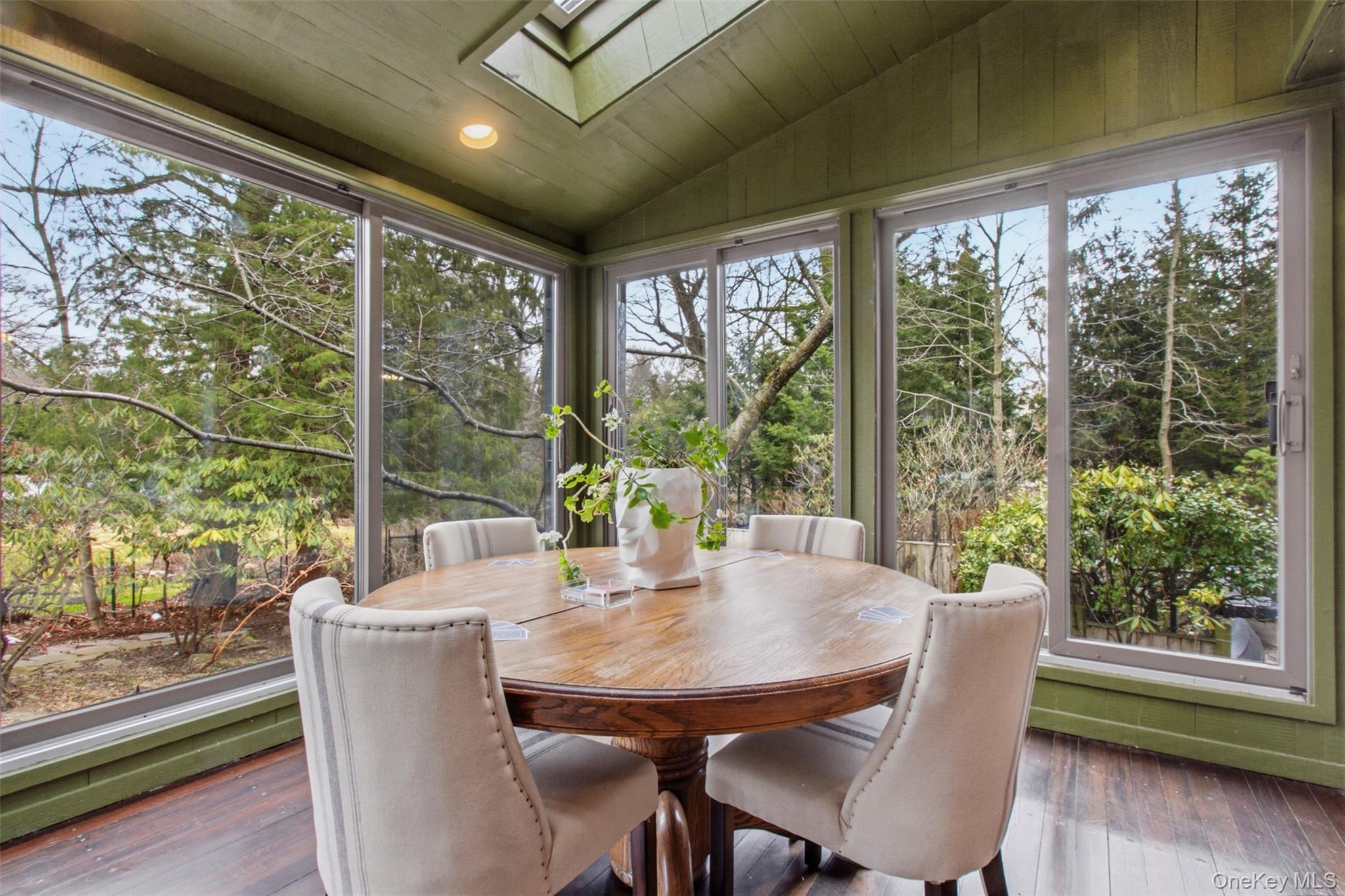 9 Rye Road Rye, NY 10580 - Photo 11 of 50 Bright sunroom with wraparound floor-to-ceiling windows and skylights.