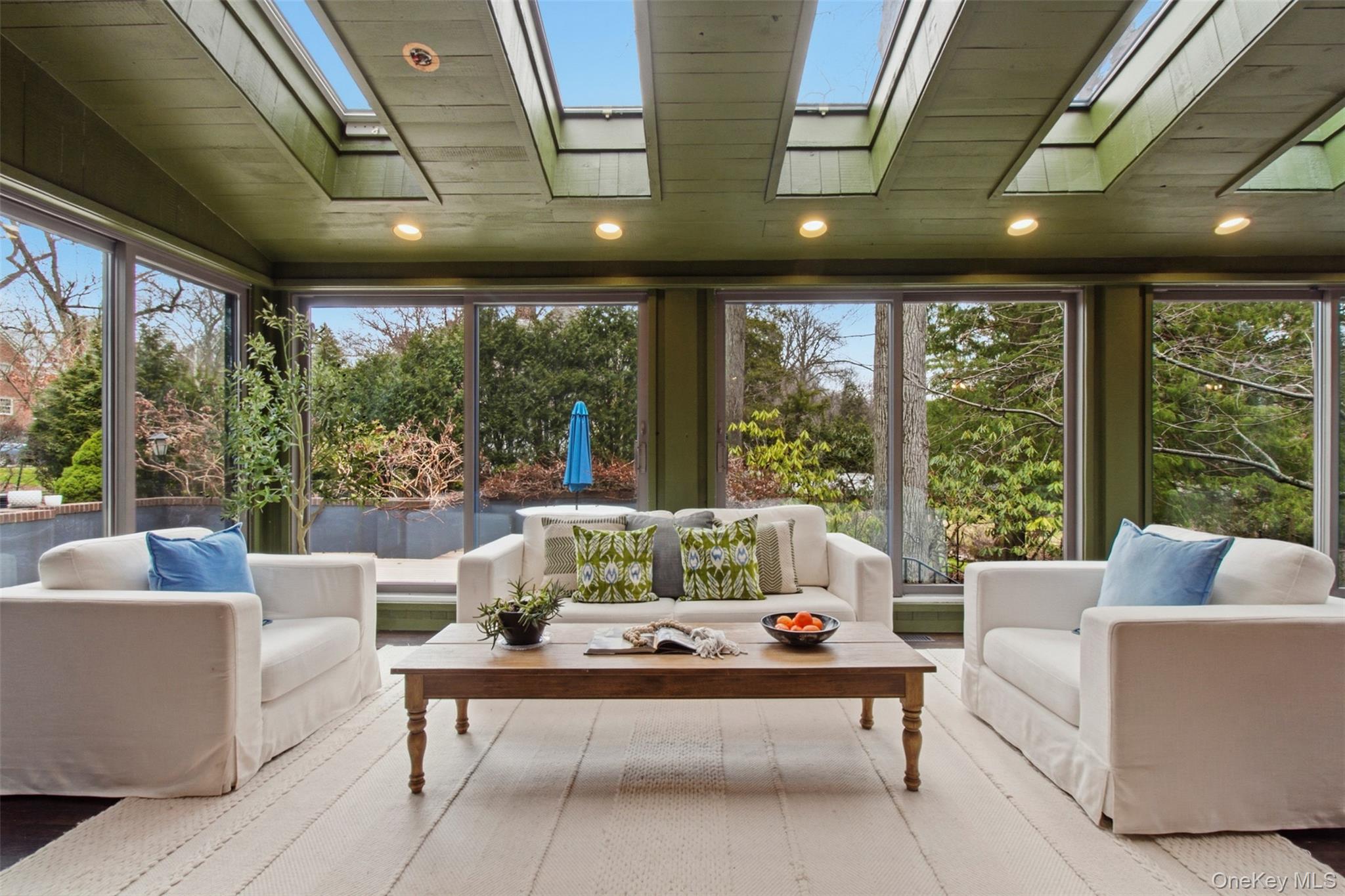 9 Rye Road Rye, NY 10580 - Photo 9 of 50 Bright sunroom with wraparound floor-to-ceiling windows and skylights.