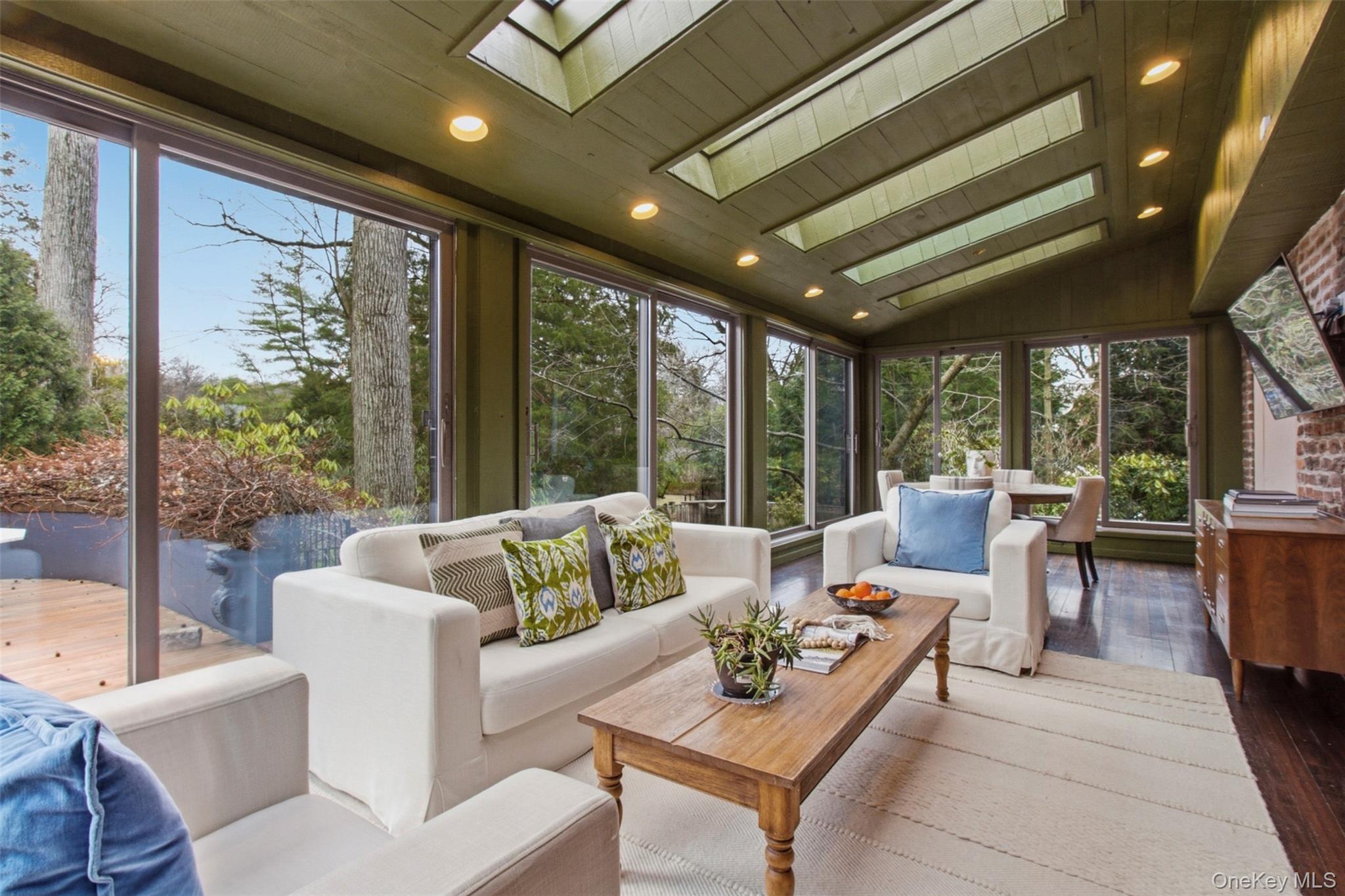 9 Rye Road Rye, NY 10580 - Photo 10 of 50 Bright sunroom with wraparound floor-to-ceiling windows and skylights.