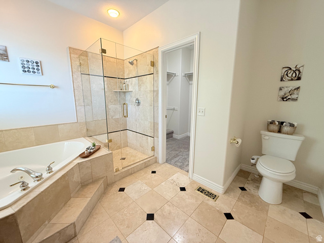1562 Fairway Ridge Road Draper, UT 84020 - Photo 30 of 60 Spacious bathroom featuring a glass-enclosed walk-in shower with tile surround, a built-in soaking tub with tiled steps, and patterned tile flooring