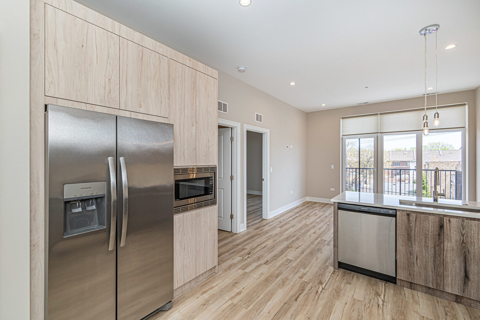 4149 South Cottage Grove Avenue, Unit 305 Chicago, IL 60653 - Photo 21 of 27 a kitchen with stainless steel appliances granite countertop a refrigerator and a sink