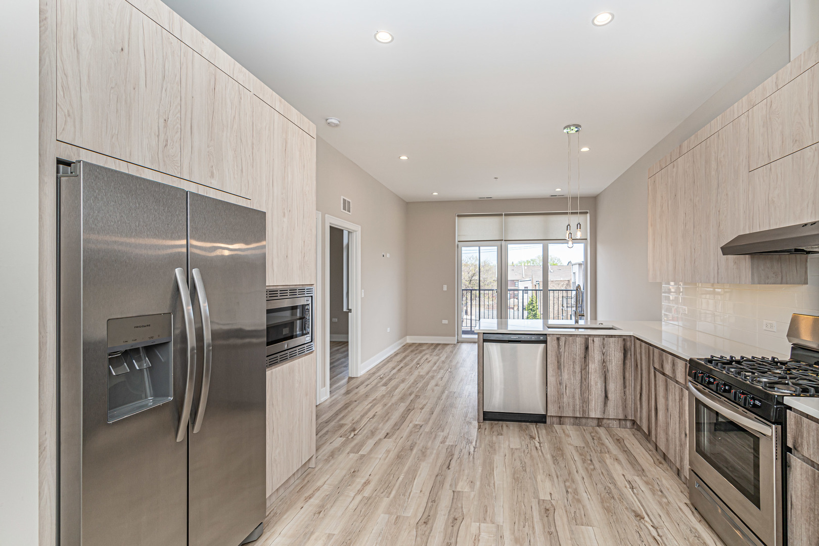 4149 South Cottage Grove Avenue, Unit 305 Chicago, IL 60653 - Photo 22 of 27 a kitchen with stainless steel appliances granite countertop a refrigerator and a sink