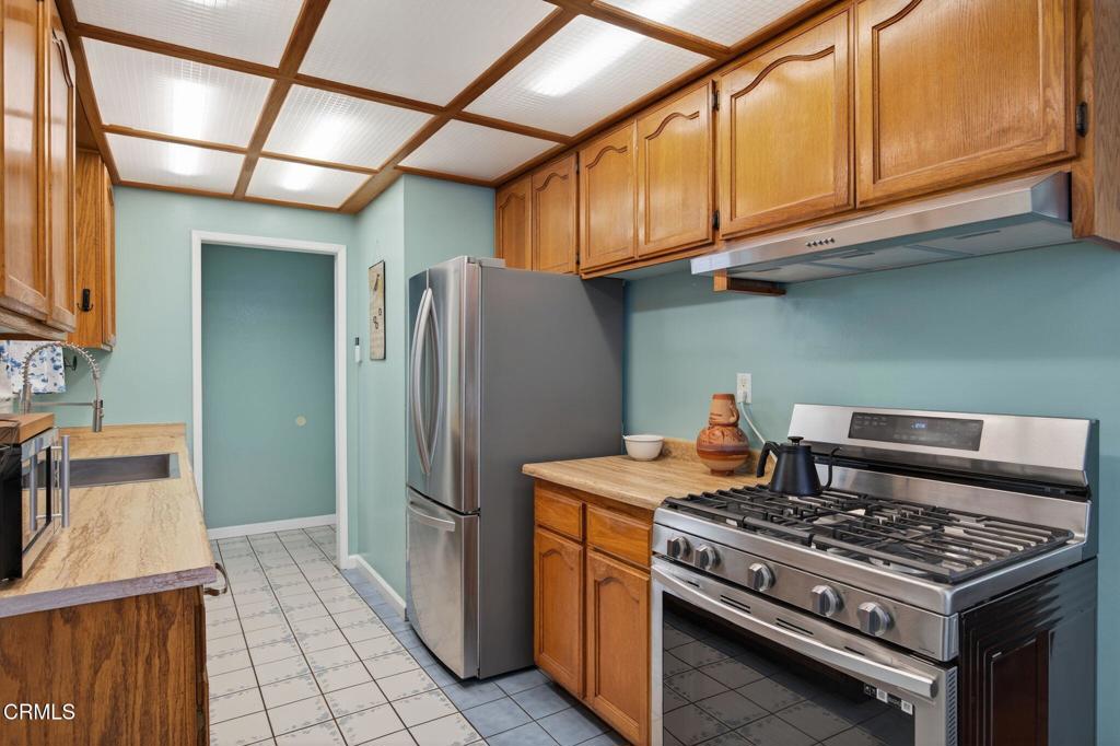 1501 Morris Street Oxnard, CA 93030 - Photo 12 of 34 a kitchen with stainless steel appliances granite countertop a stove and a refrigerator