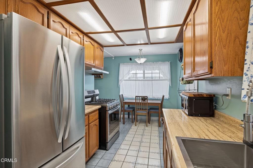 1501 Morris Street Oxnard, CA 93030 - Photo 16 of 34 a kitchen with stainless steel appliances granite countertop a refrigerator and a stove top oven