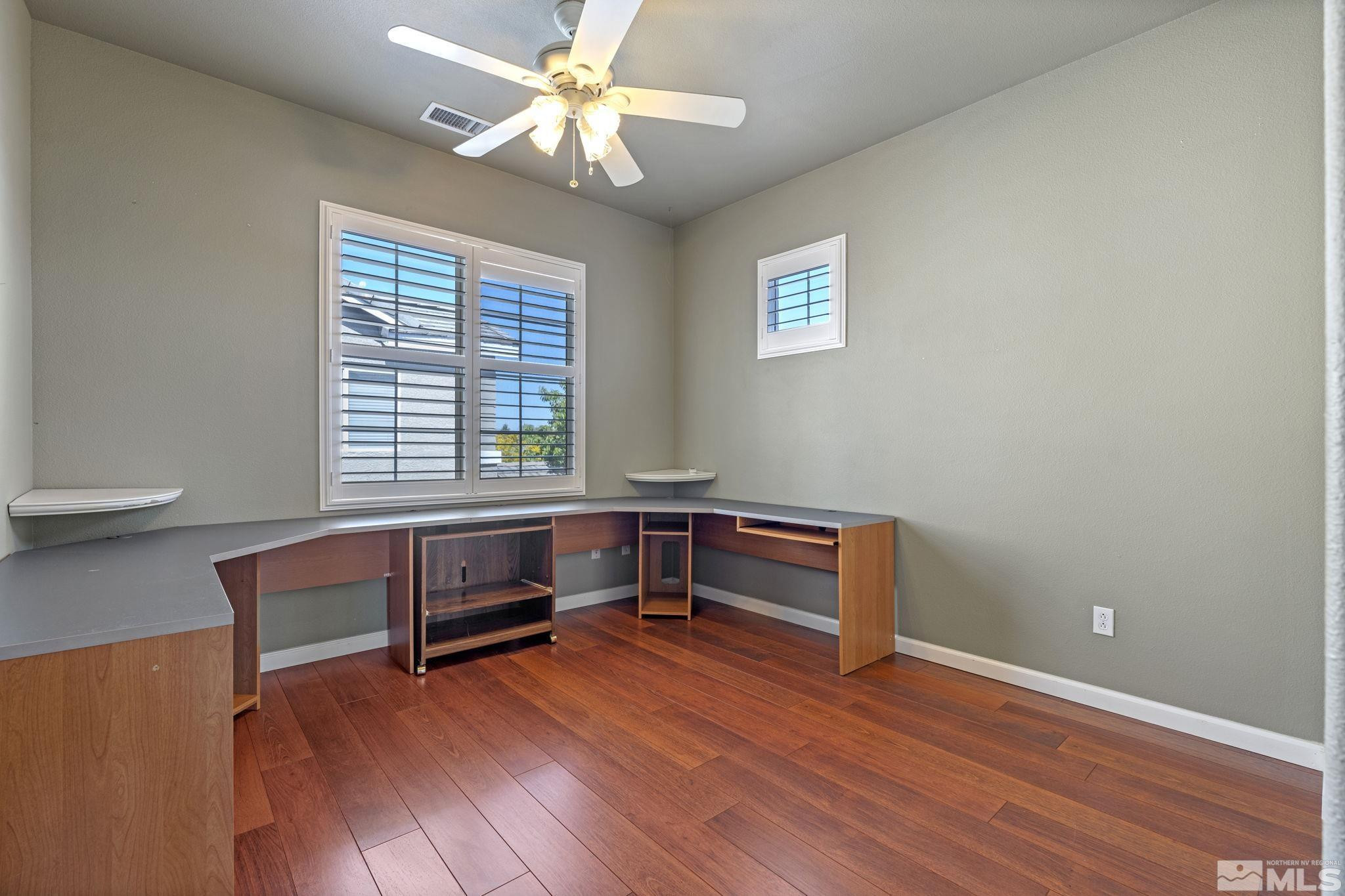 10568 Iron Point Circle Reno, NV 89521 - Photo 12 of 30 a view of room with wooden floor and fan