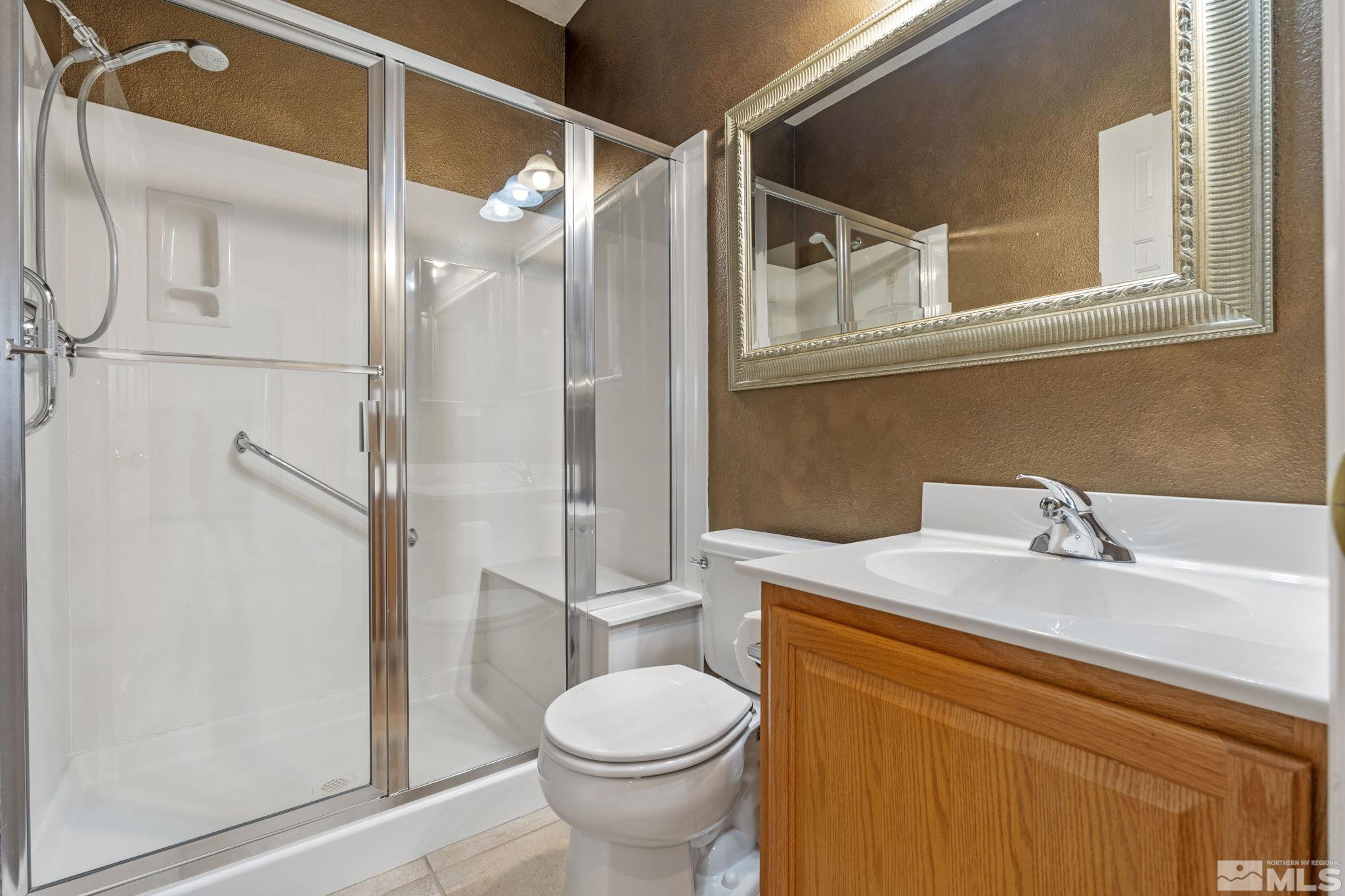 10568 Iron Point Circle Reno, NV 89521 - Photo 13 of 30 a bathroom with a sink toilet and shower