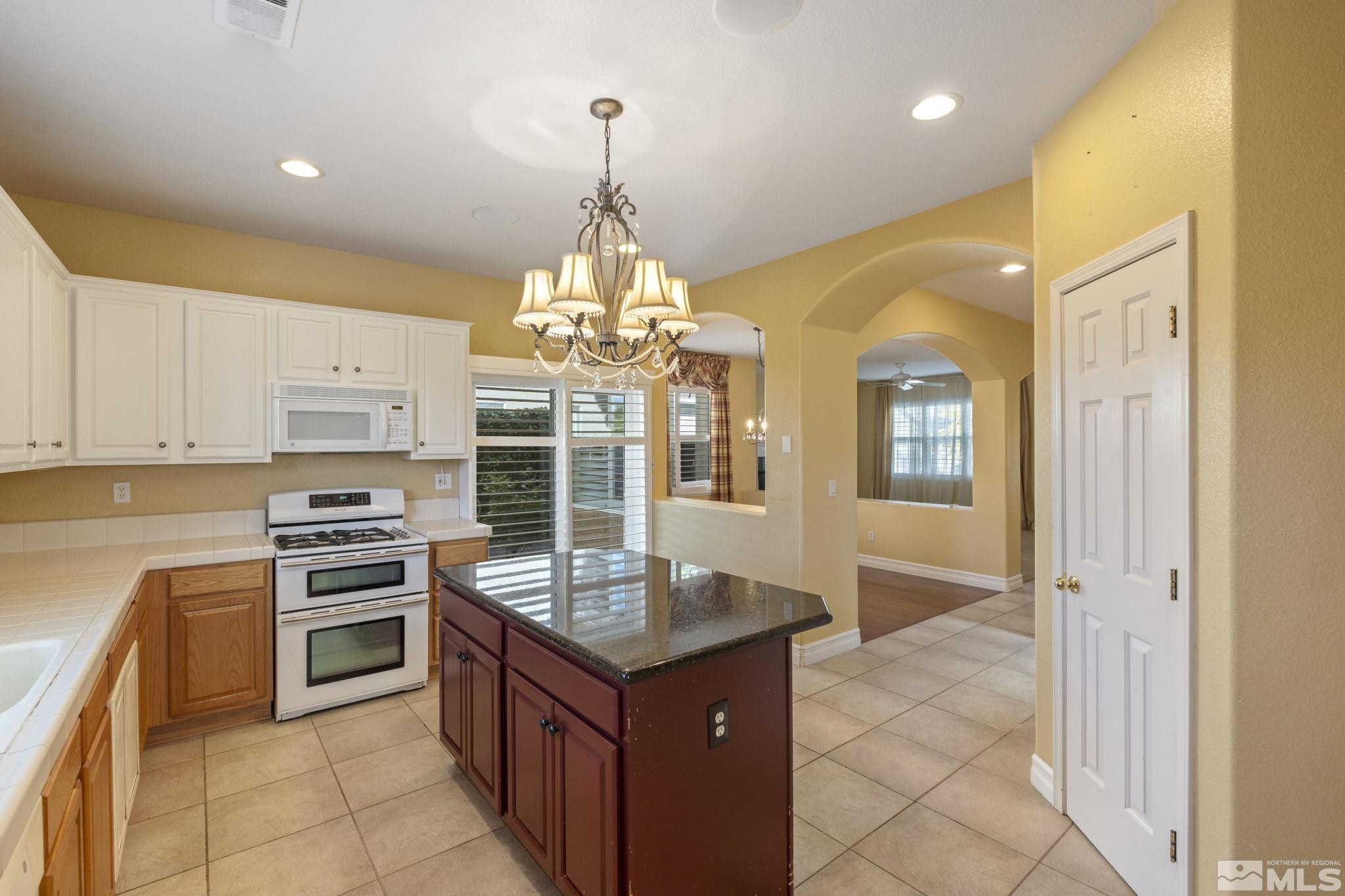 10568 Iron Point Circle Reno, NV 89521 - Photo 16 of 30 a kitchen with stainless steel appliances granite countertop a stove and a sink