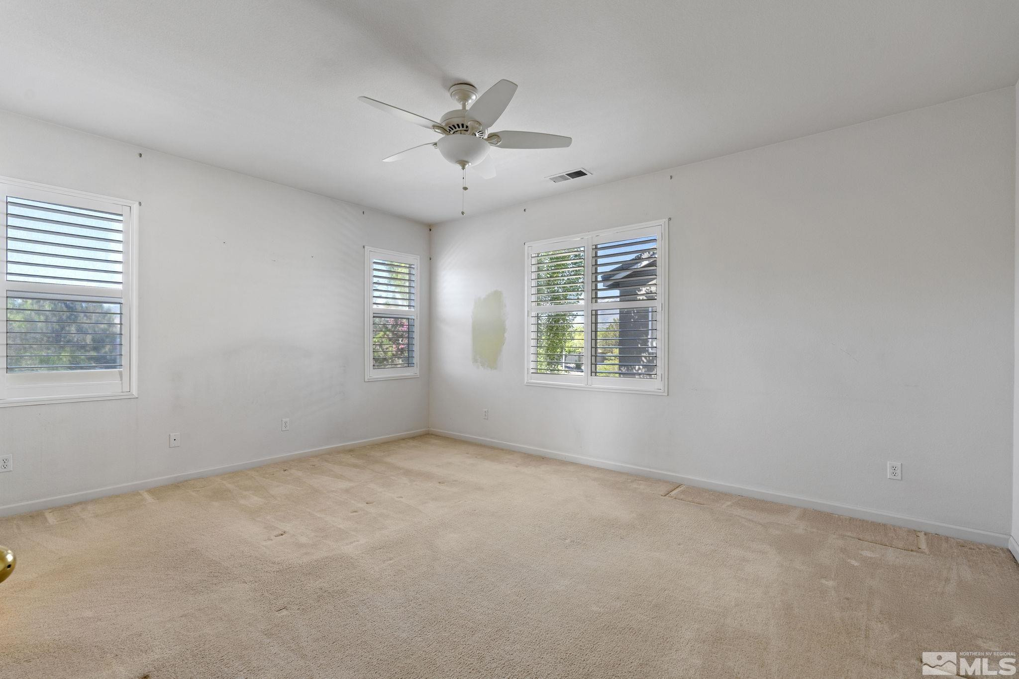 10568 Iron Point Circle Reno, NV 89521 - Photo 19 of 30 an empty room with windows and fan