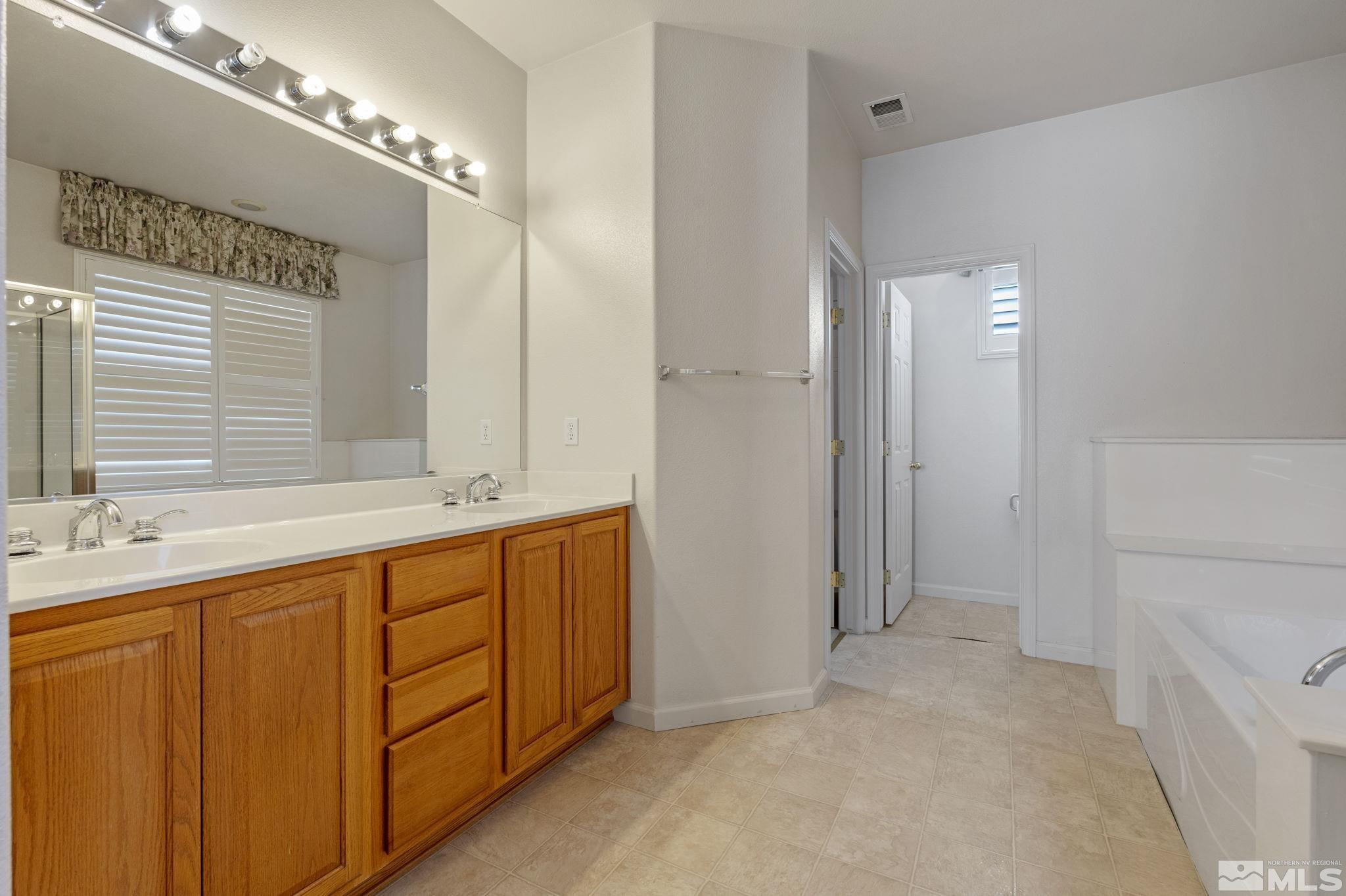10568 Iron Point Circle Reno, NV 89521 - Photo 20 of 30 a bathroom with a sink and a mirror