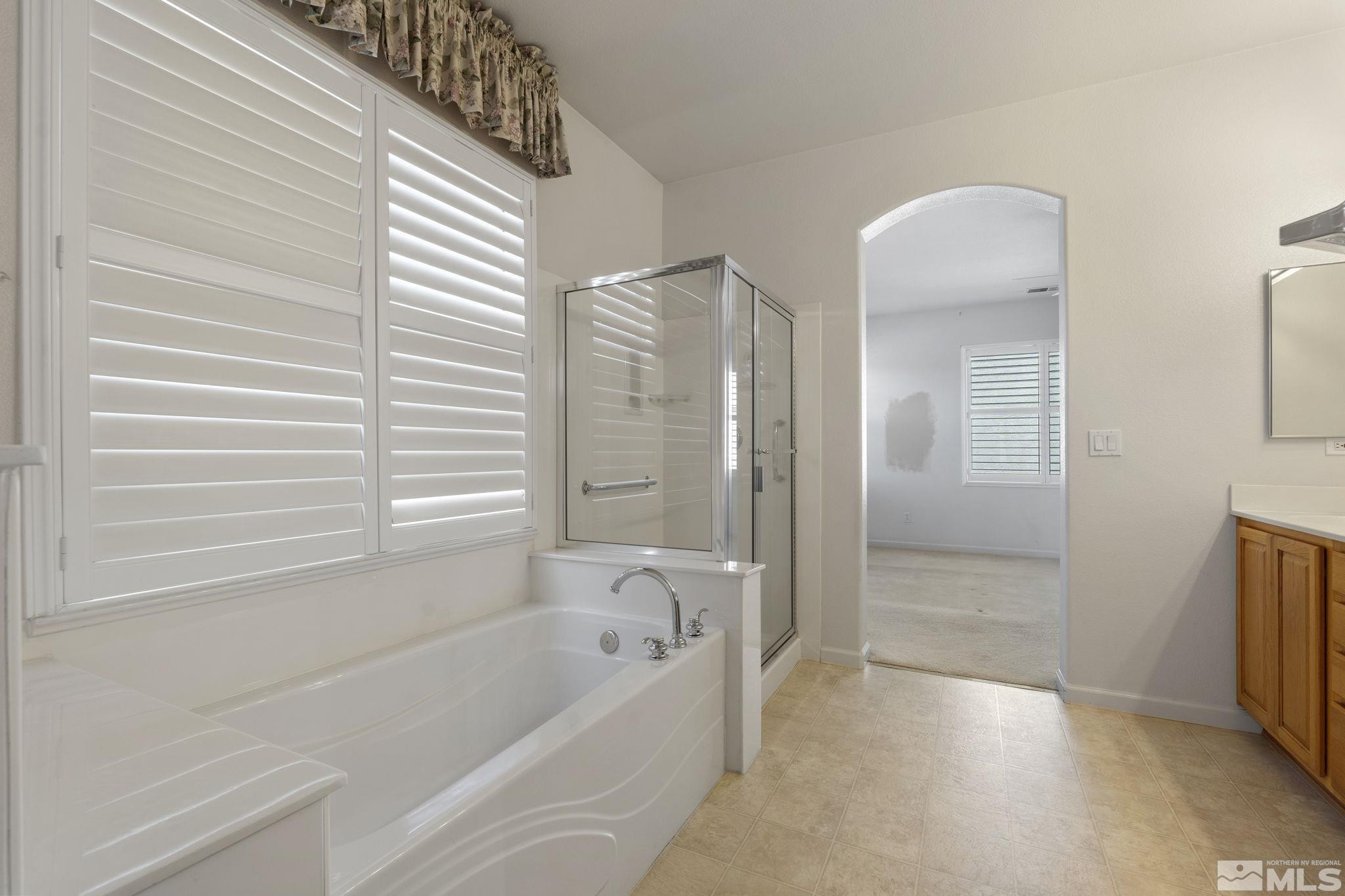 10568 Iron Point Circle Reno, NV 89521 - Photo 21 of 30 a bathroom with a bathtub and a shower