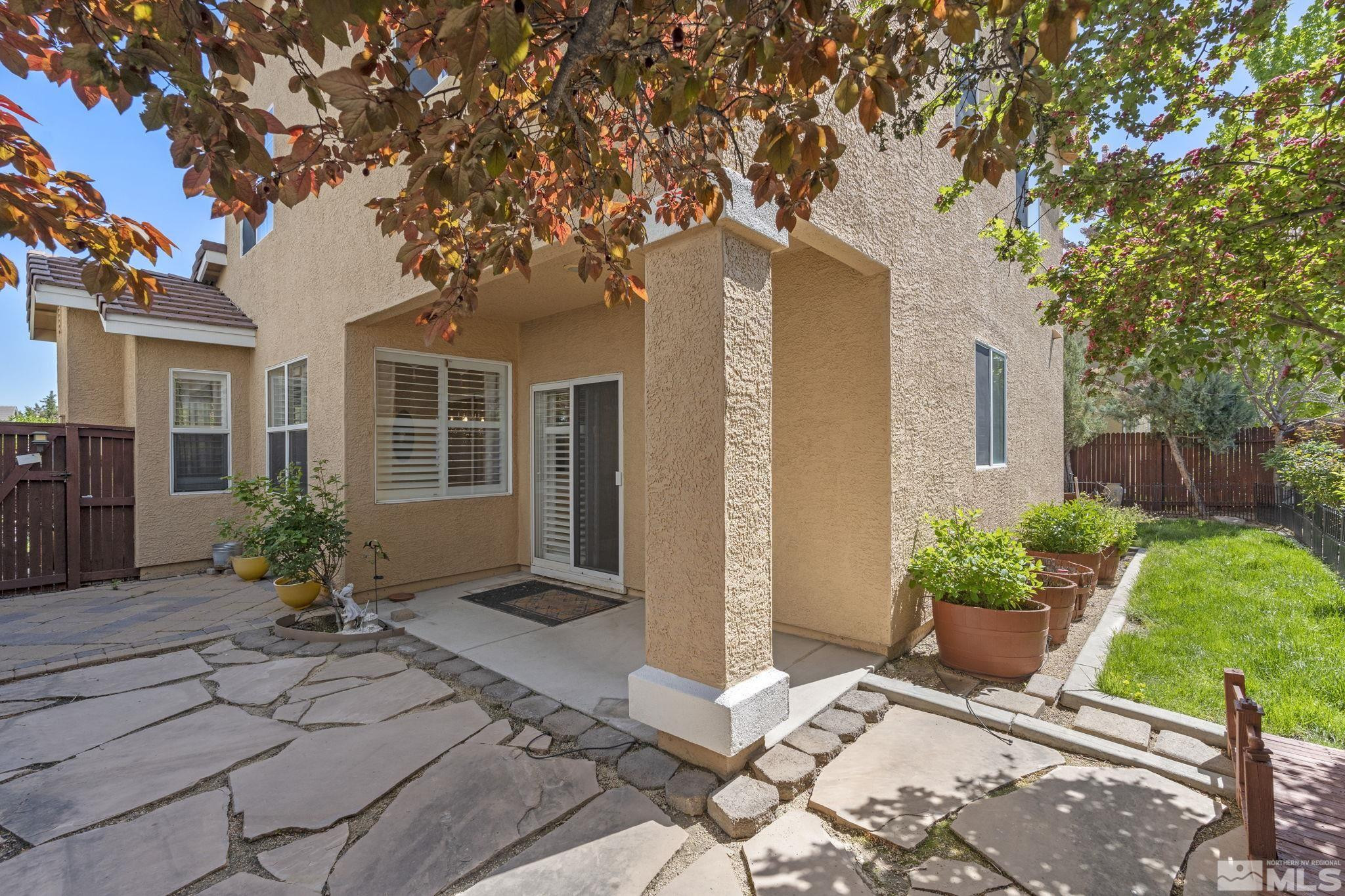 10568 Iron Point Circle Reno, NV 89521 - Photo 27 of 30 a front view of a house with a garden