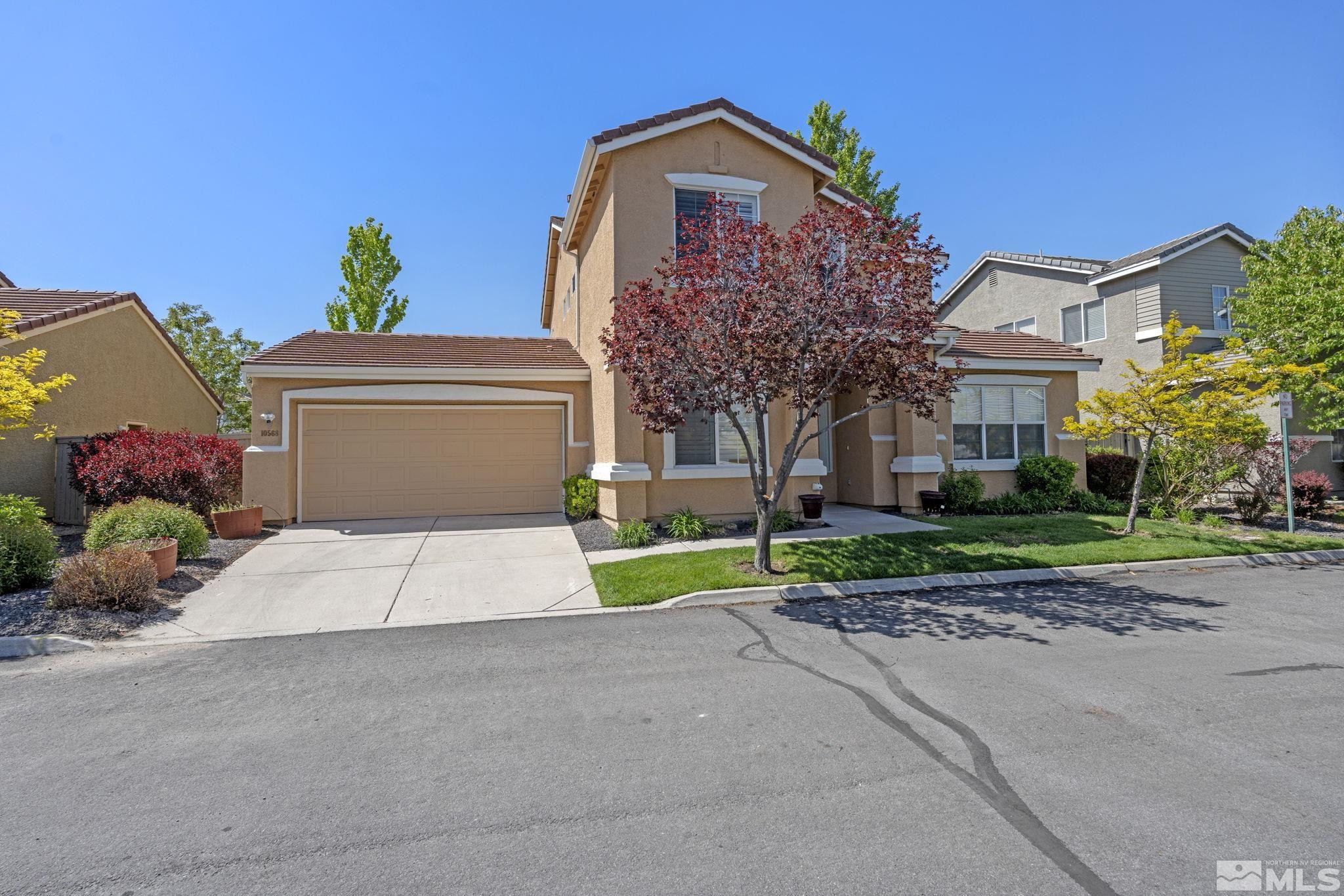 10568 Iron Point Circle Reno, NV 89521 - Photo 3 of 30 a front view of a house with a yard and a garage