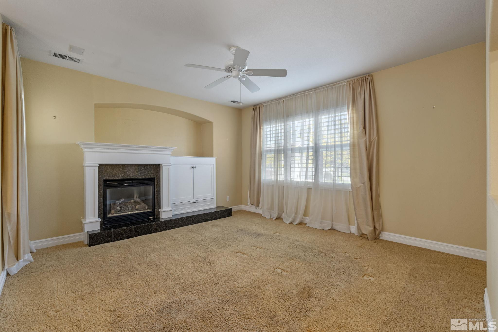 10568 Iron Point Circle Reno, NV 89521 - Photo 5 of 30 an empty room with windows and fireplace