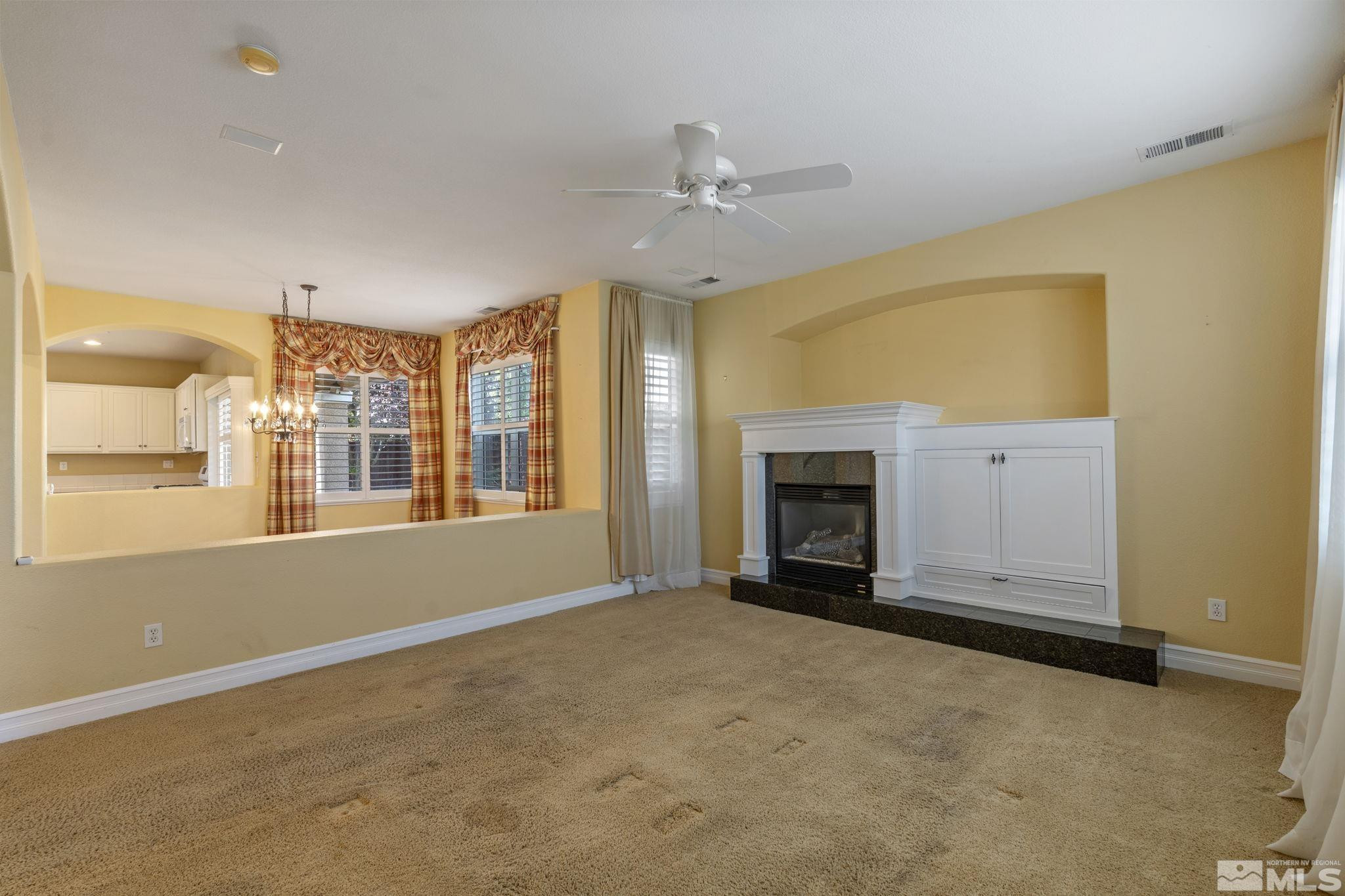 10568 Iron Point Circle Reno, NV 89521 - Photo 7 of 30 a view of an empty room with a fireplace and a window