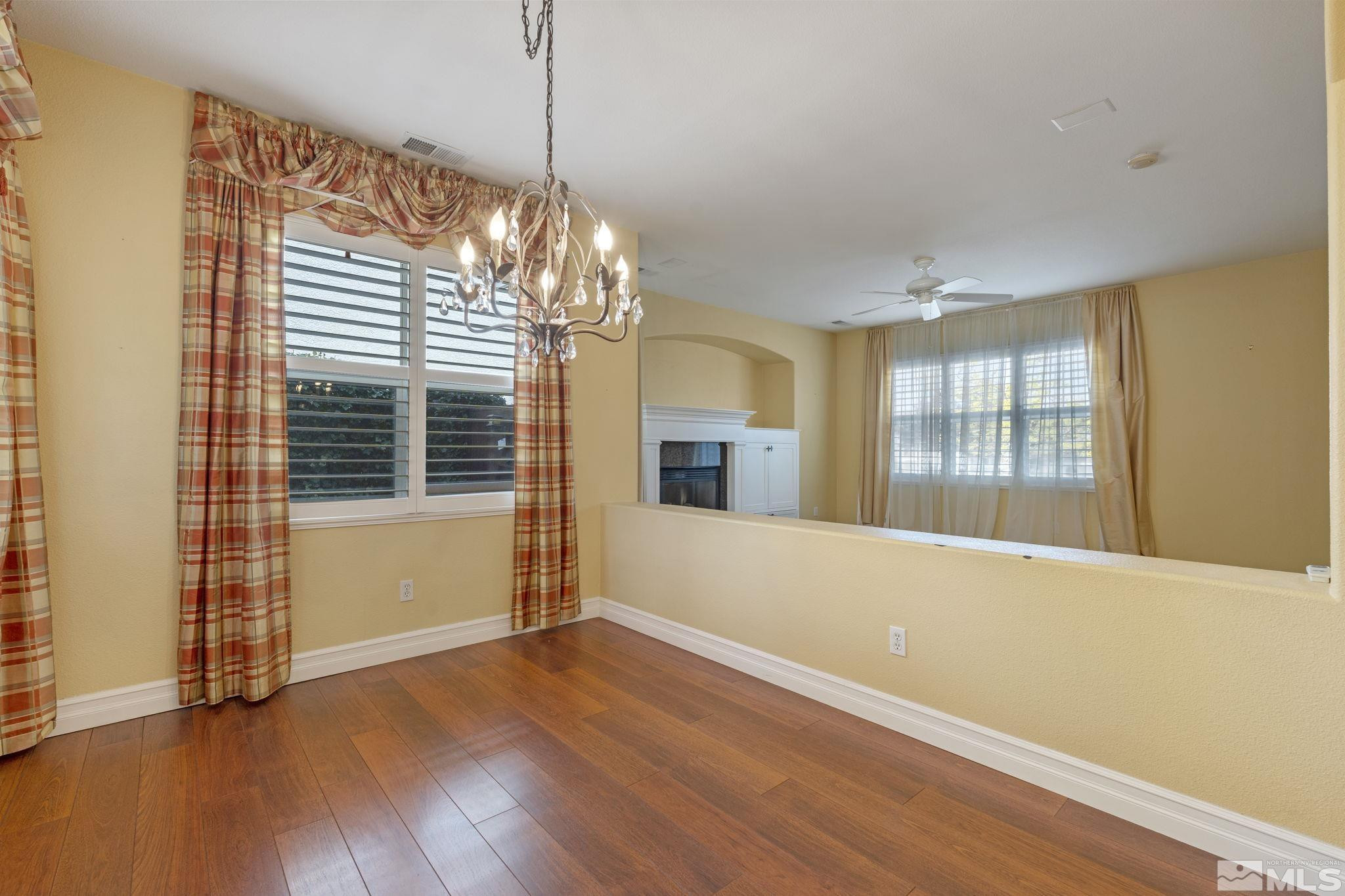 10568 Iron Point Circle Reno, NV 89521 - Photo 10 of 30 a view of an empty room with wooden floor and a window
