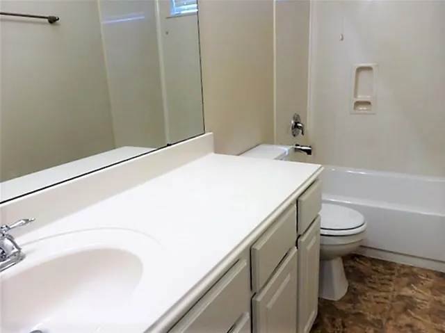 a bathroom with a sink and toilet