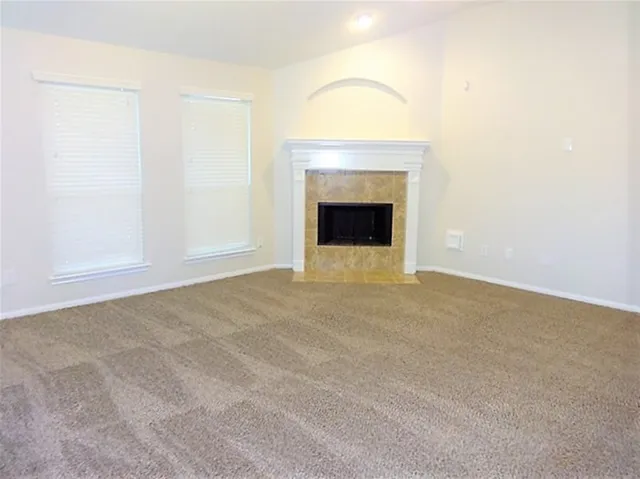 a view of an empty room with a fireplace