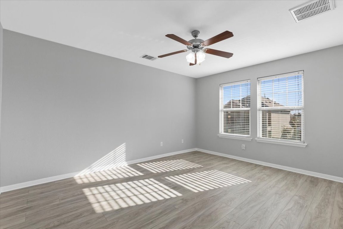 4524 Kind Way, Unit 257 Austin, TX 78725 - Photo 5 of 16 Unfurnished room with light wood finished floors and ceiling fan