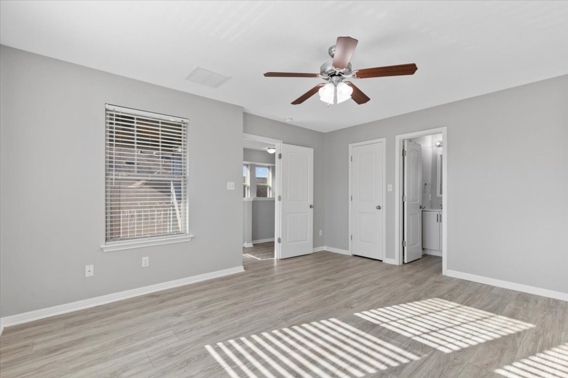 4524 Kind Way, Unit 257 Austin, TX 78725 - Photo 7 of 16 Unfurnished bedroom featuring light wood-style floors and ceiling fan
