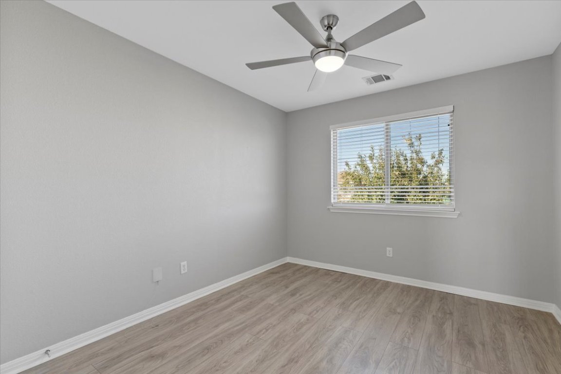 4524 Kind Way, Unit 257 Austin, TX 78725 - Photo 9 of 16 Empty room featuring light wood-style flooring and ceiling fan