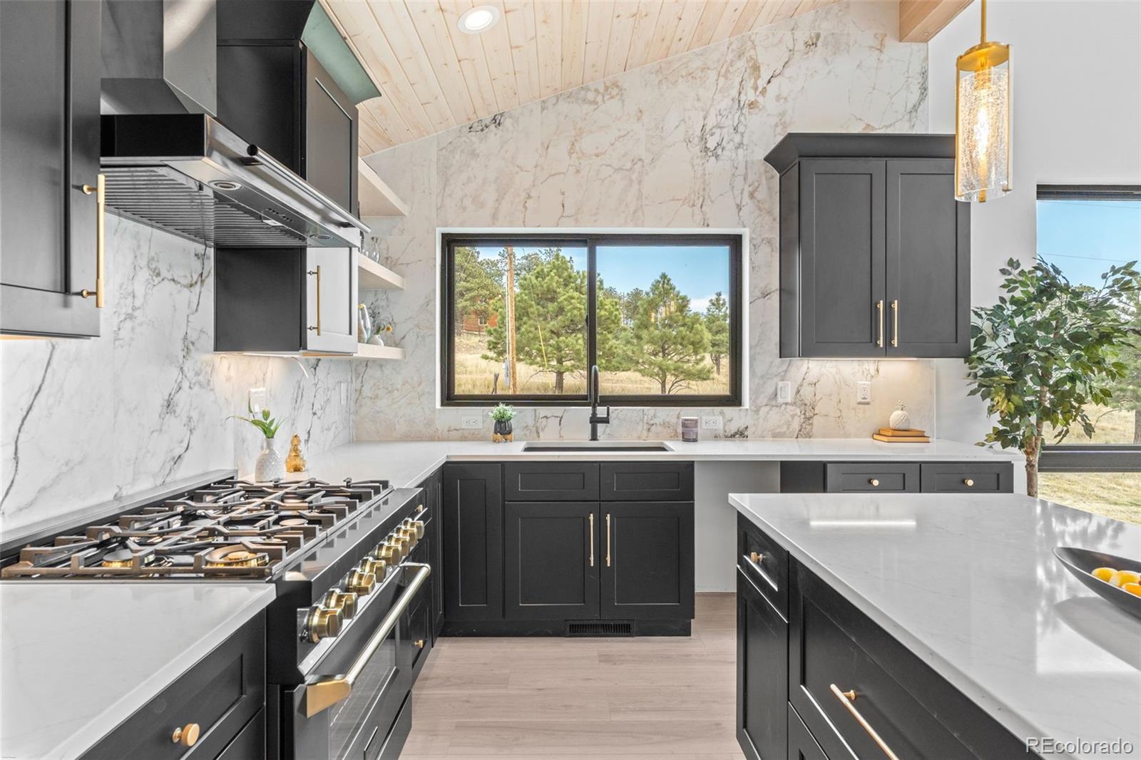 542 Conifer Drive Bailey, CO 80421 - Photo 20 of 47 a kitchen with a sink stove and cabinets