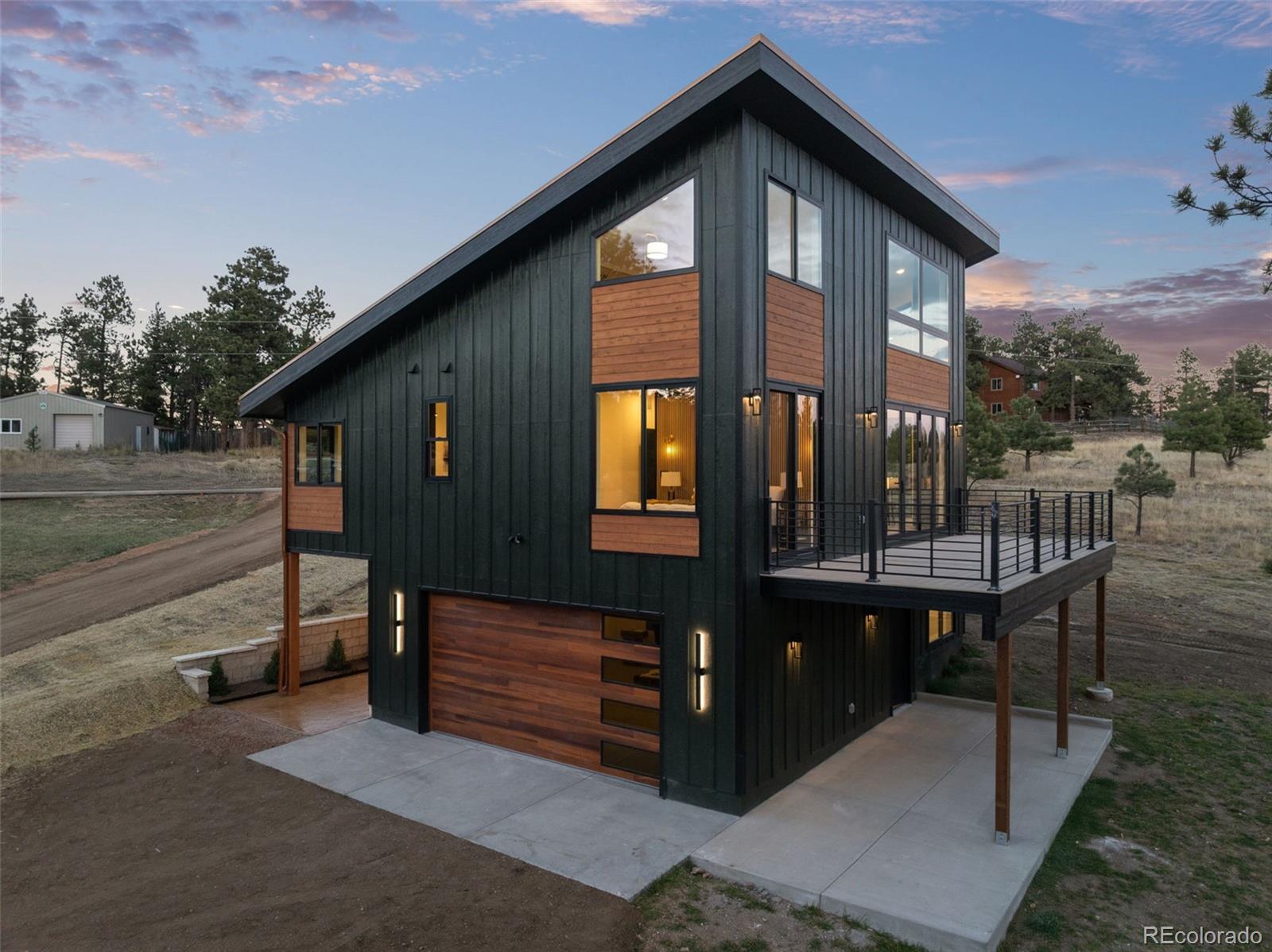 542 Conifer Drive Bailey, CO 80421 - Photo 2 of 47 a front view of a house with a yard